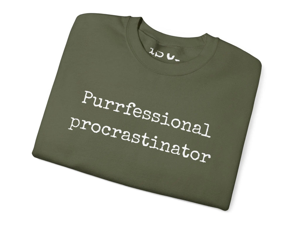 Folded green t-shirt with 'Purrfessional procrastinator' text on a white background