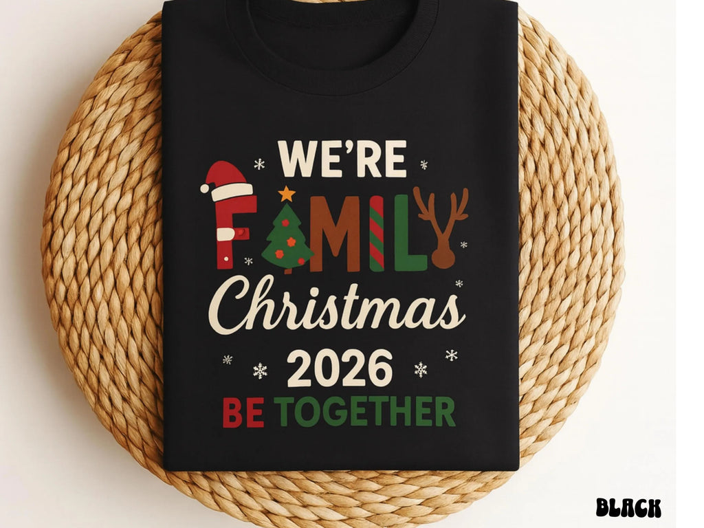 Black t-shirt with Christmas-themed text and graphics on a woven surface