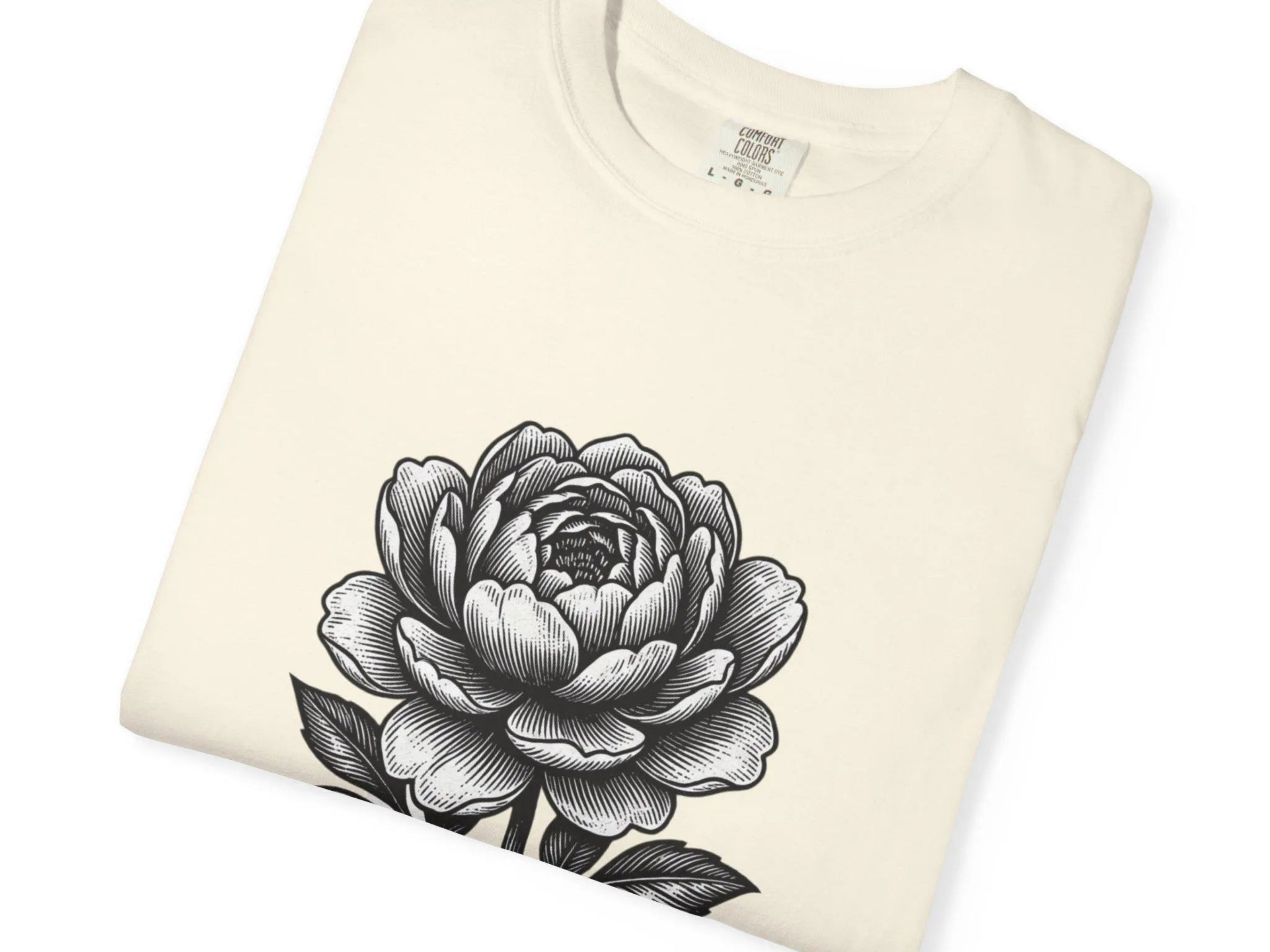 Folded cream-colored sweatshirt with a black floral design on a white background