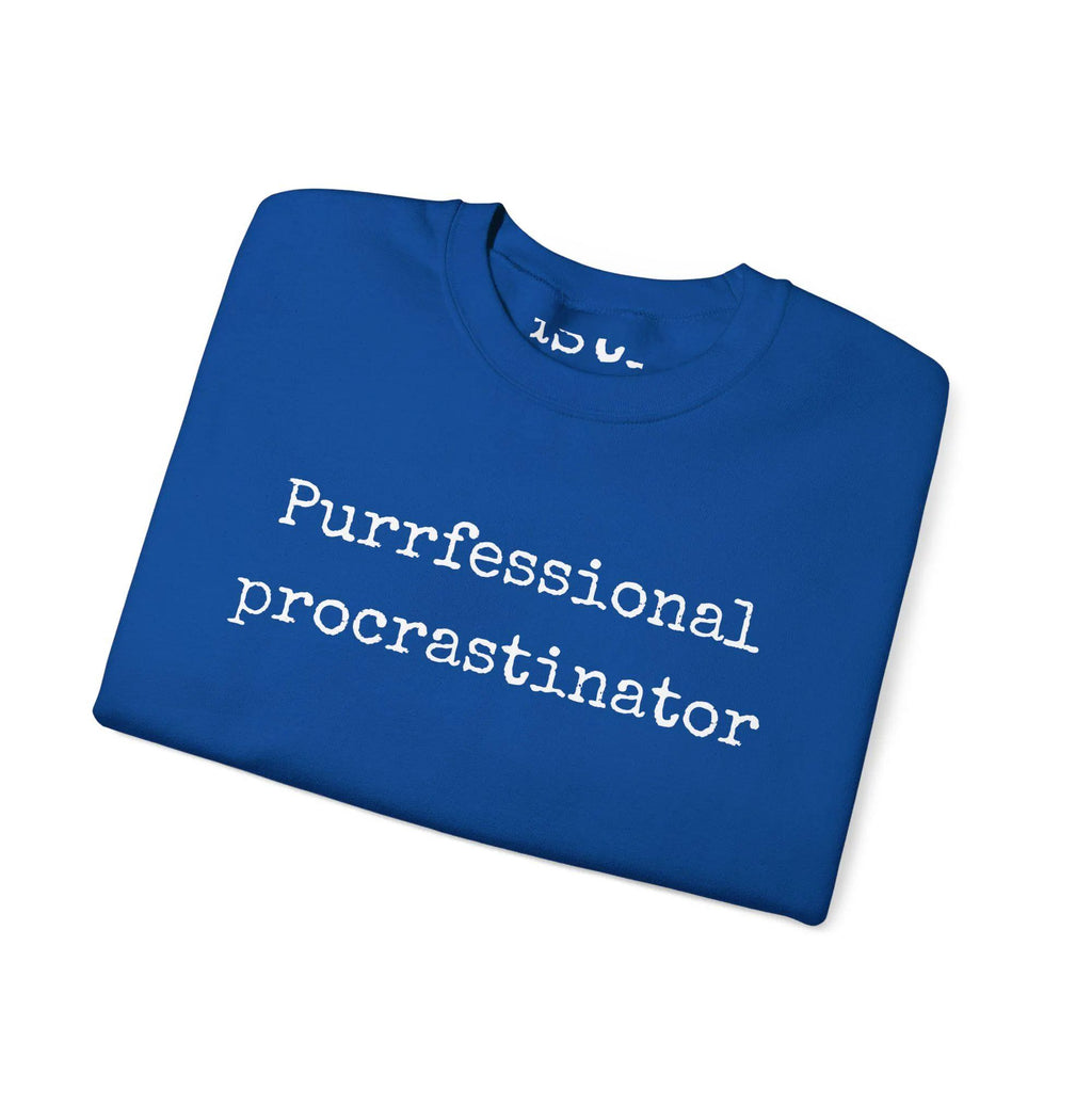 Folded blue t-shirt with 'Purfessional procrastinator' text on a white background