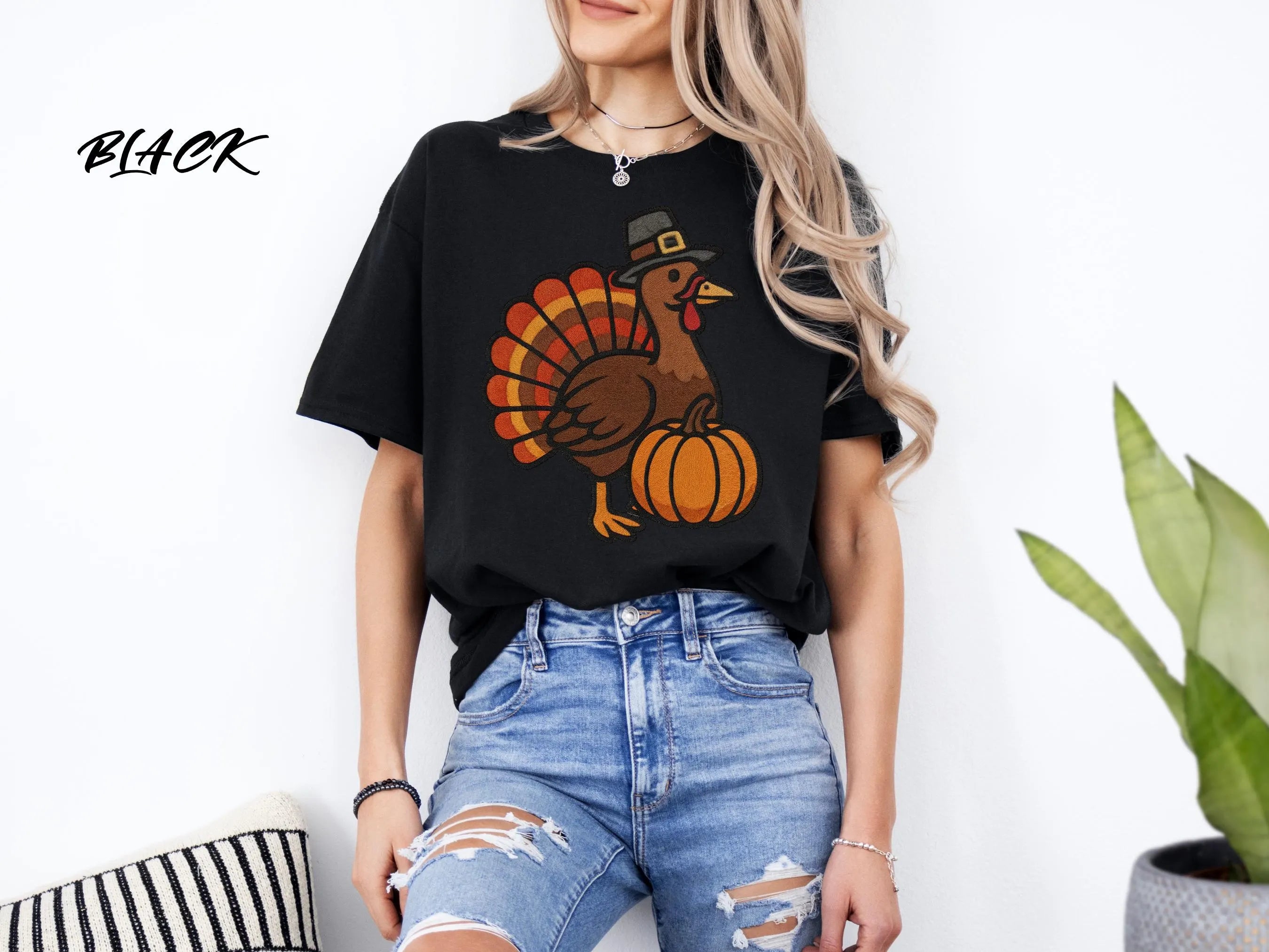 Black t-shirt featuring a pilgrim turkey and pumpkin graphic ideal for a Thanksgiving or fall holiday gift