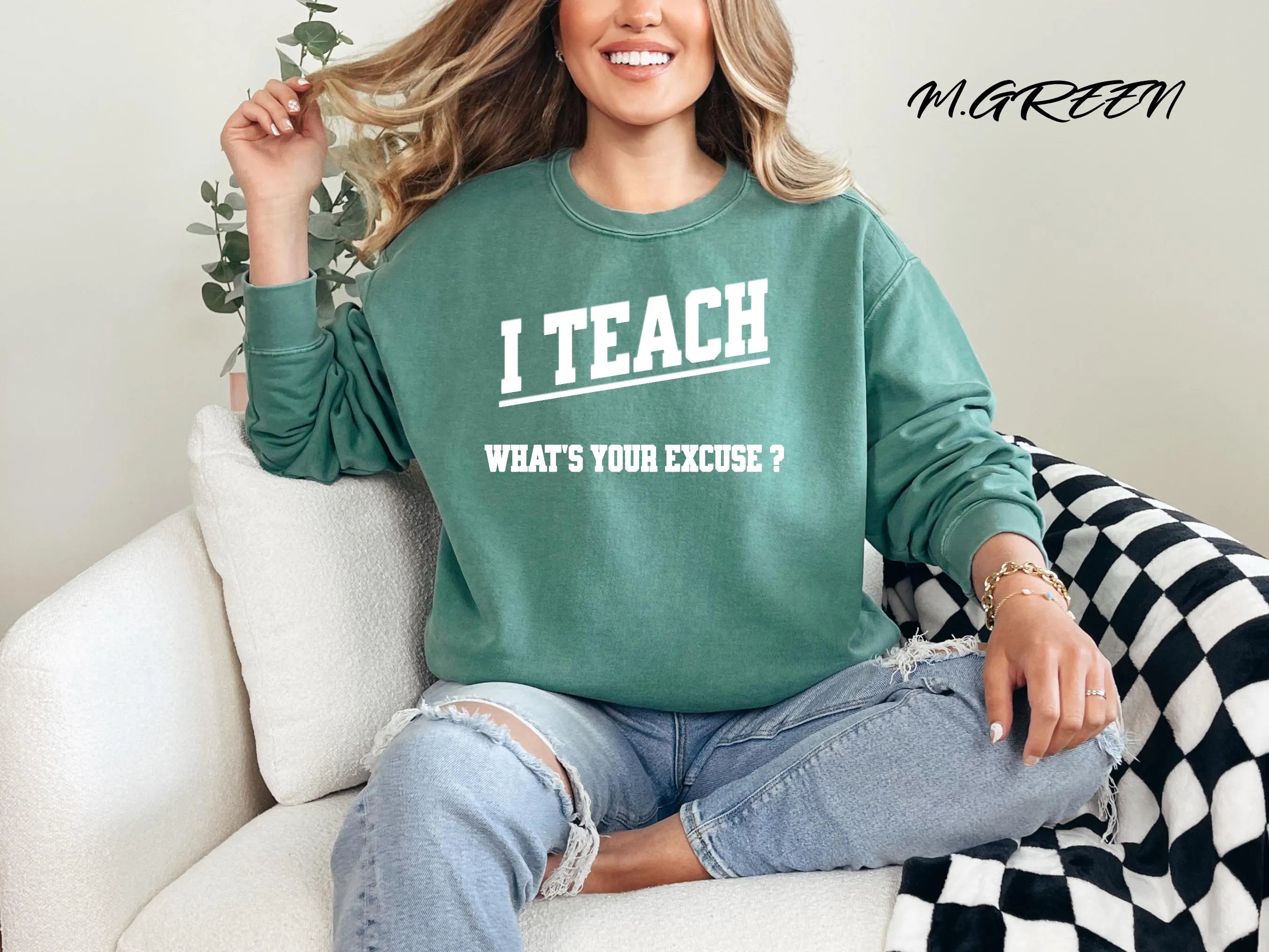 Woman wearing a green sweatshirt with text, sitting on a couch.