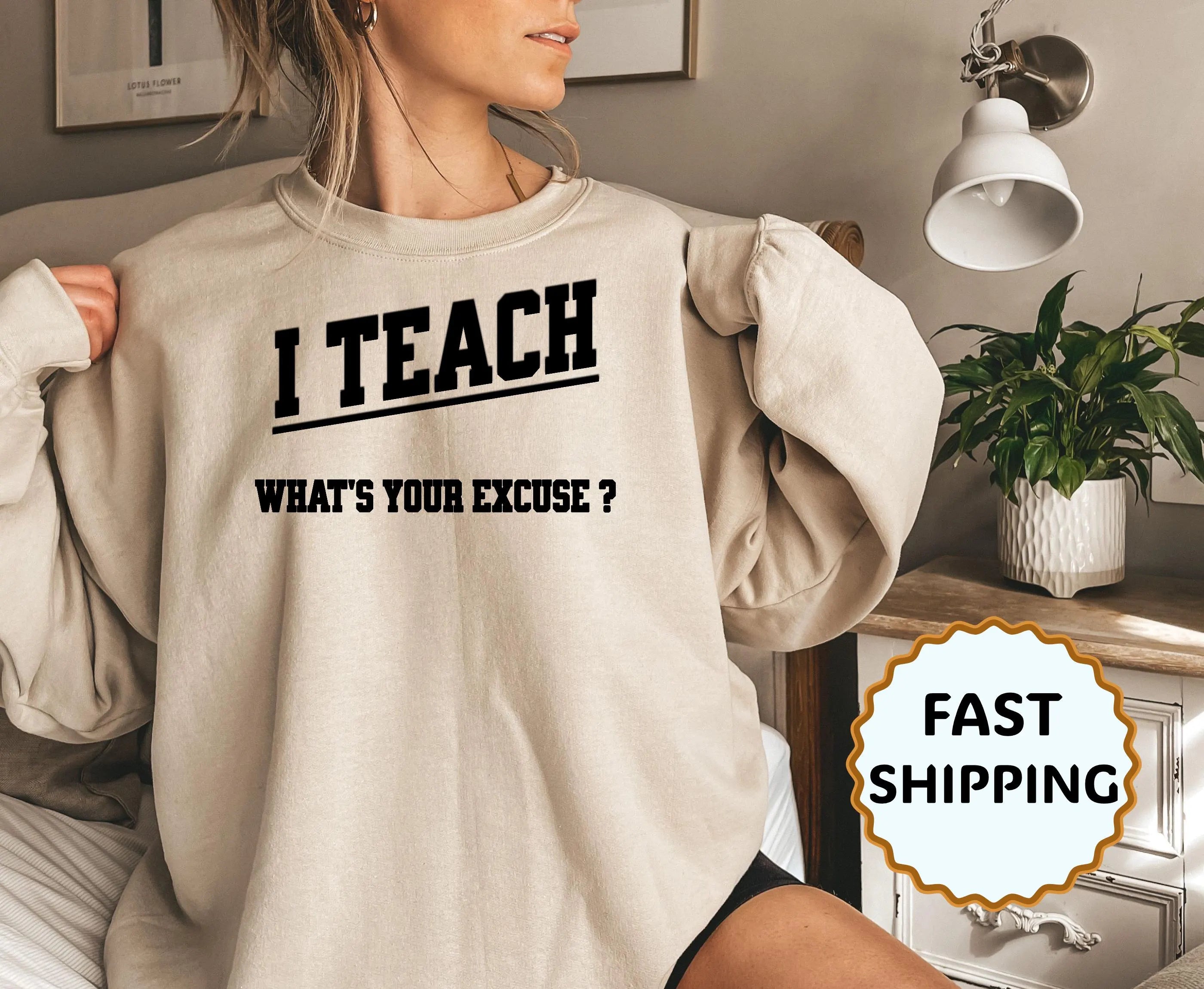Person wearing a beige sweatshirt with text, sitting in a room with decor elements.