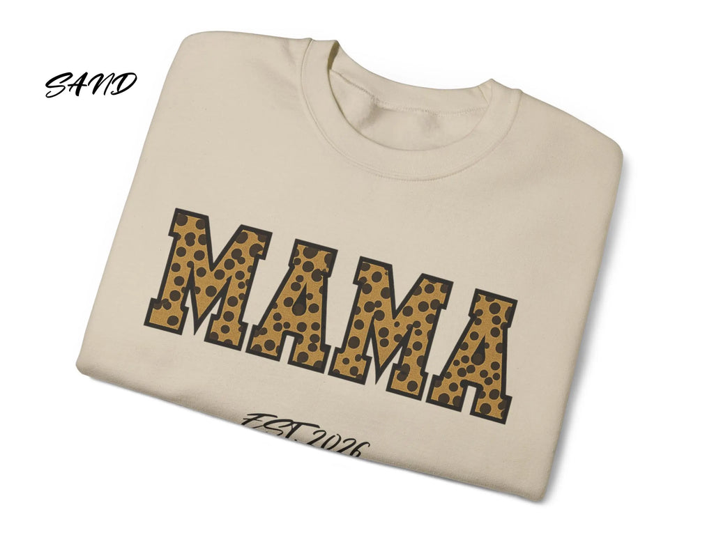 Folded beige sweatshirt with 'MAMA' in leopard print on a white background