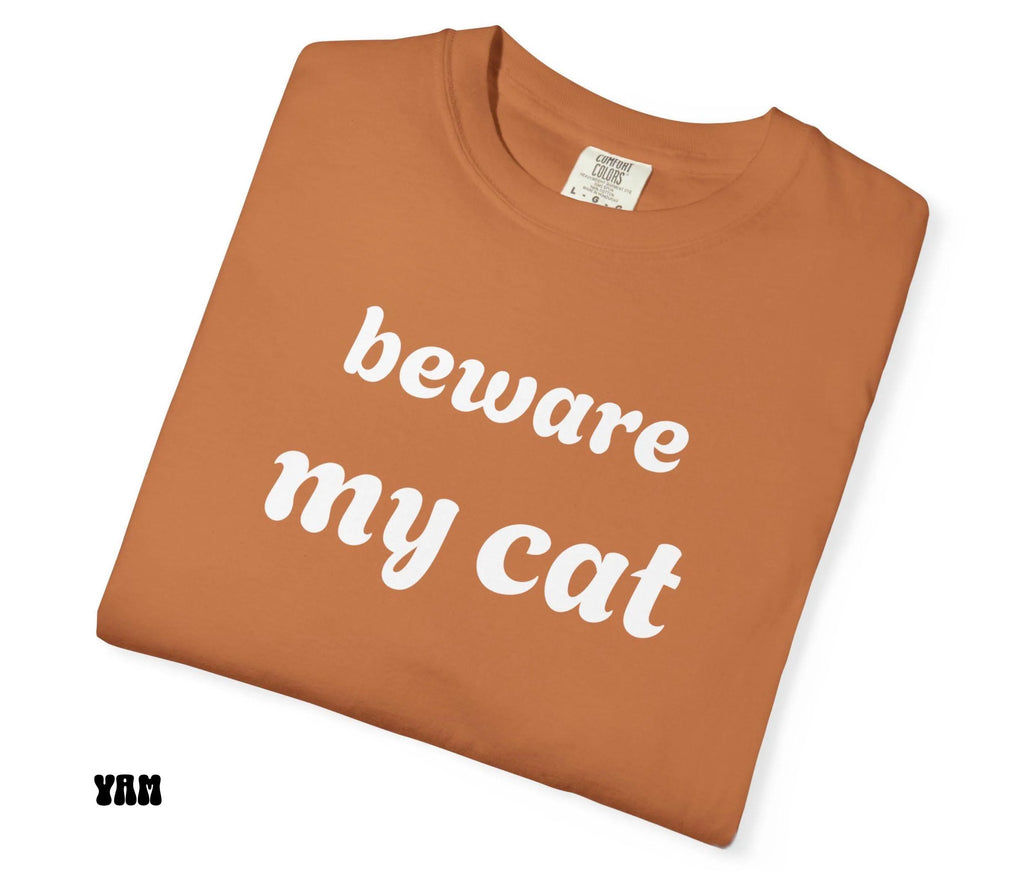 Brown t-shirt with 'beware my cat' text on a white background