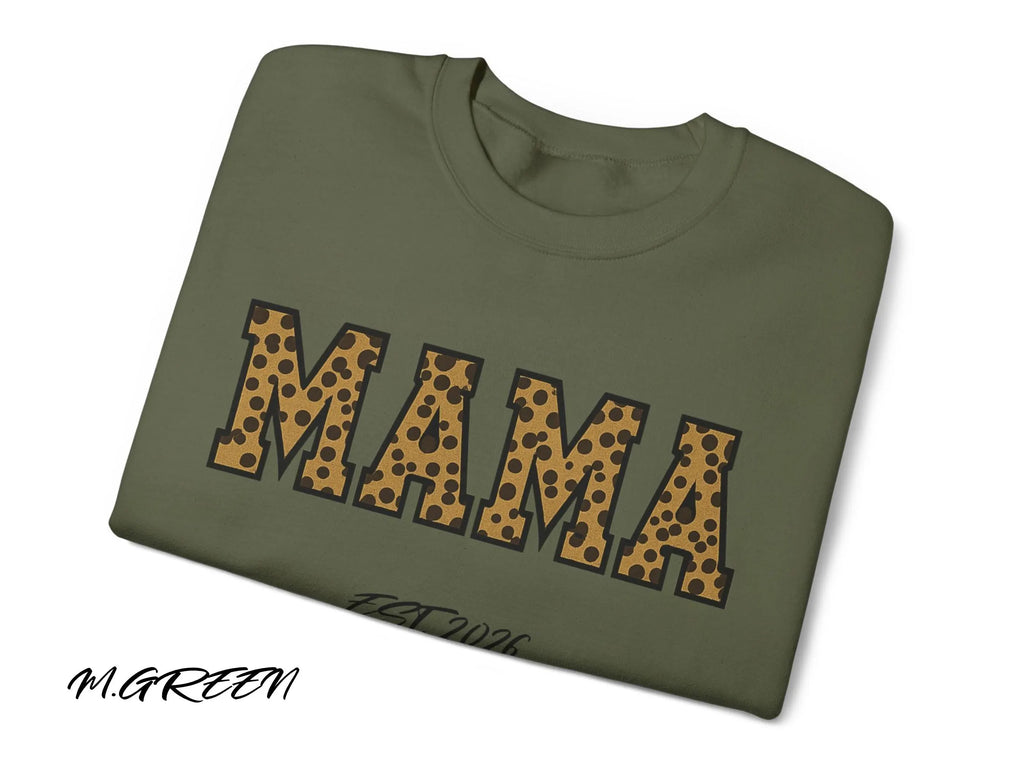 Folded green sweatshirt with 'MAMA' in leopard print on a white background