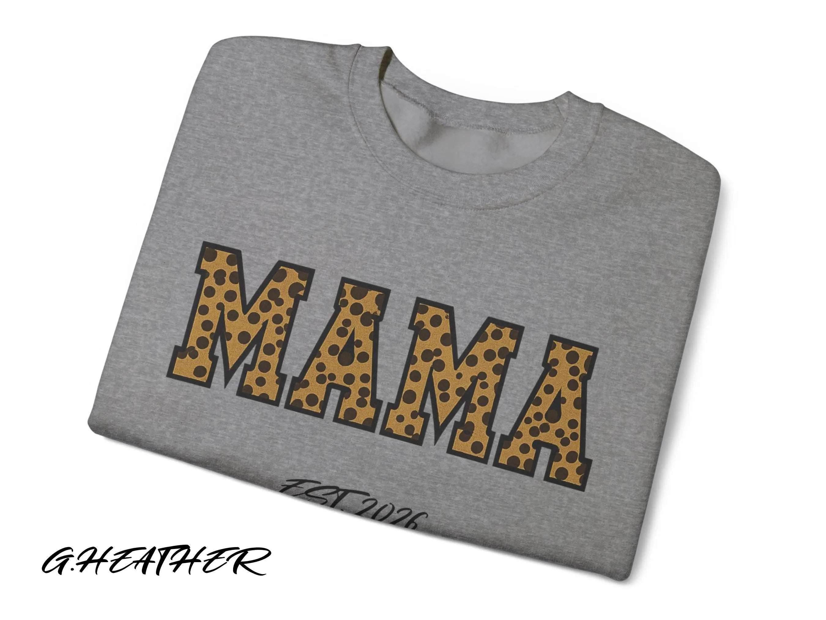 Folded gray t-shirt with 'MAMA' in leopard print on a white background