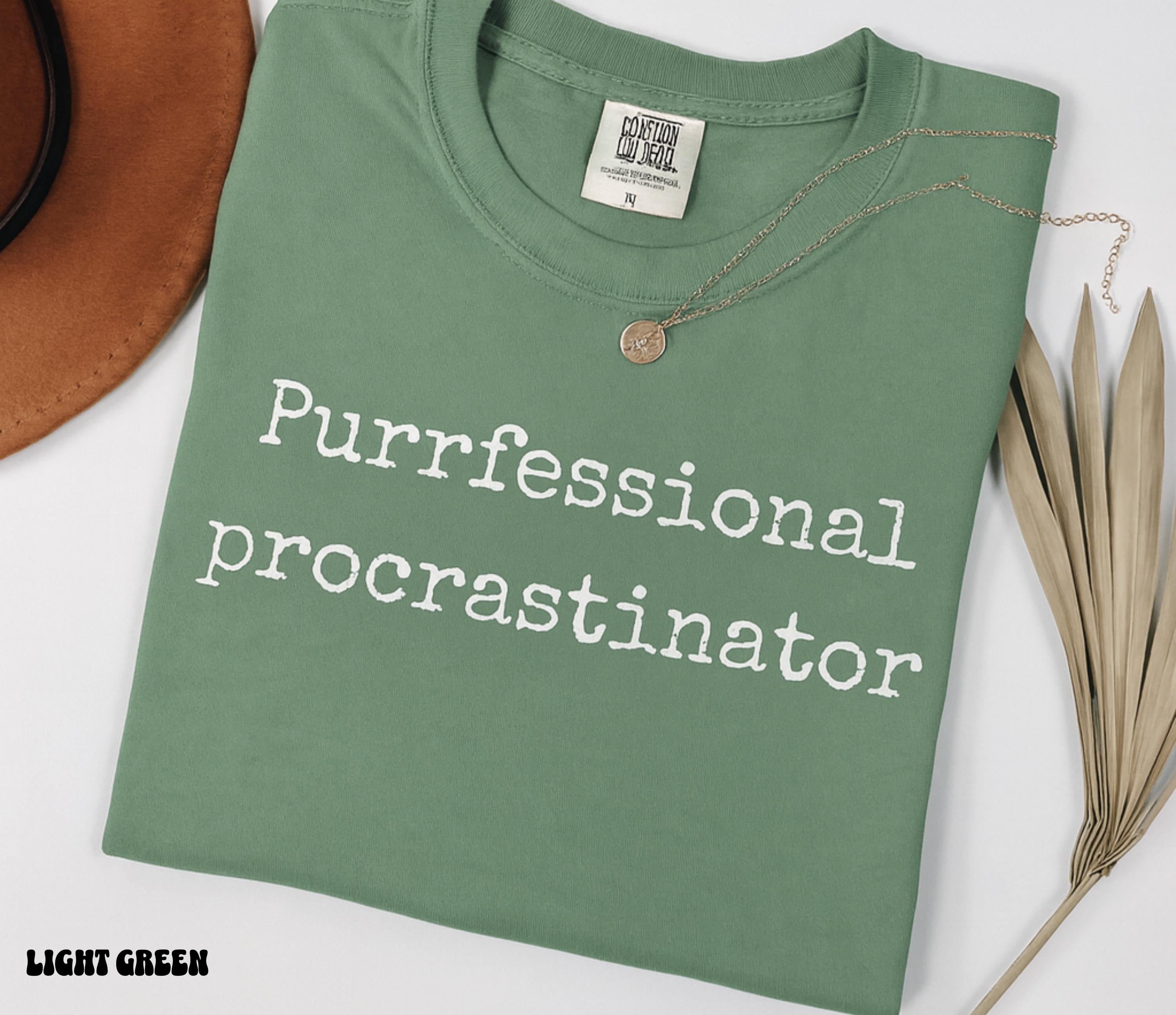 Green t-shirt with 'Purfessional procrastinator' text on a white background