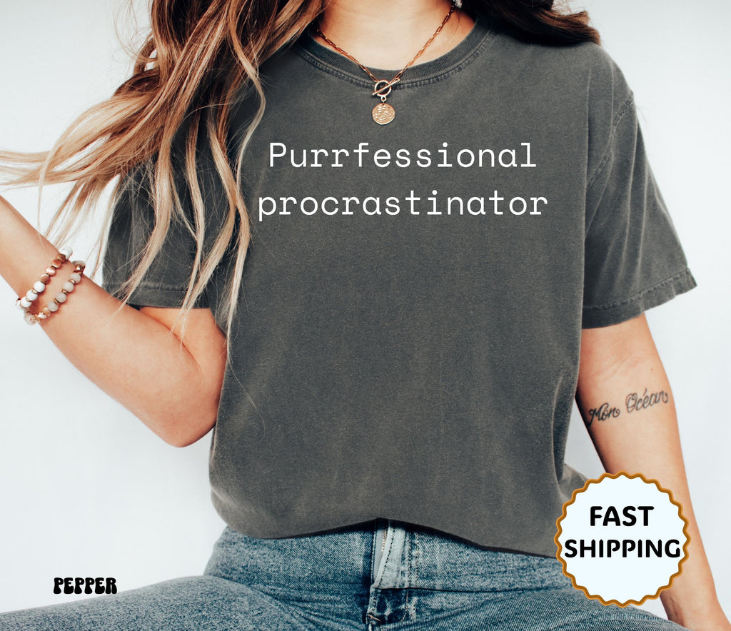 Person wearing a gray t-shirt with 'Purfessional procrastinator' text on a white background